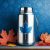 "Stainless steel YETI Rambler® 3.7 L Jug featured on a modern banner with a gradient blue and white background, accented by maple leaf and parcel icons representing Canada and shipping.